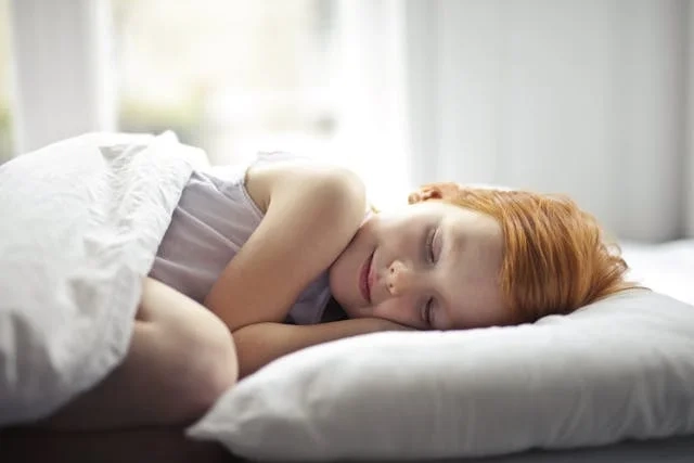 A girl sleeping on the bed