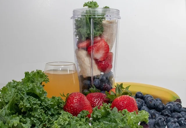 making a fruit smoothie with bananas, strawberries and leafy greens.