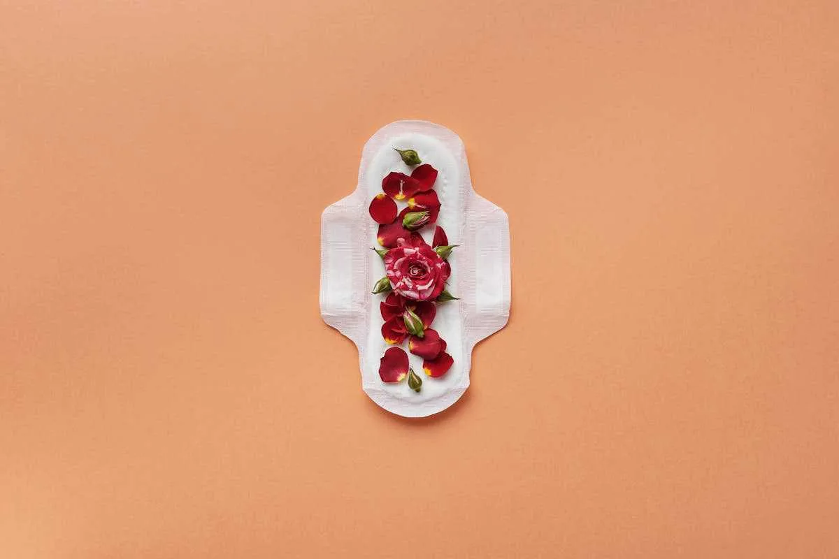 Red flower petals on a period napkin referring the benefits of mushroom coffee at that time.