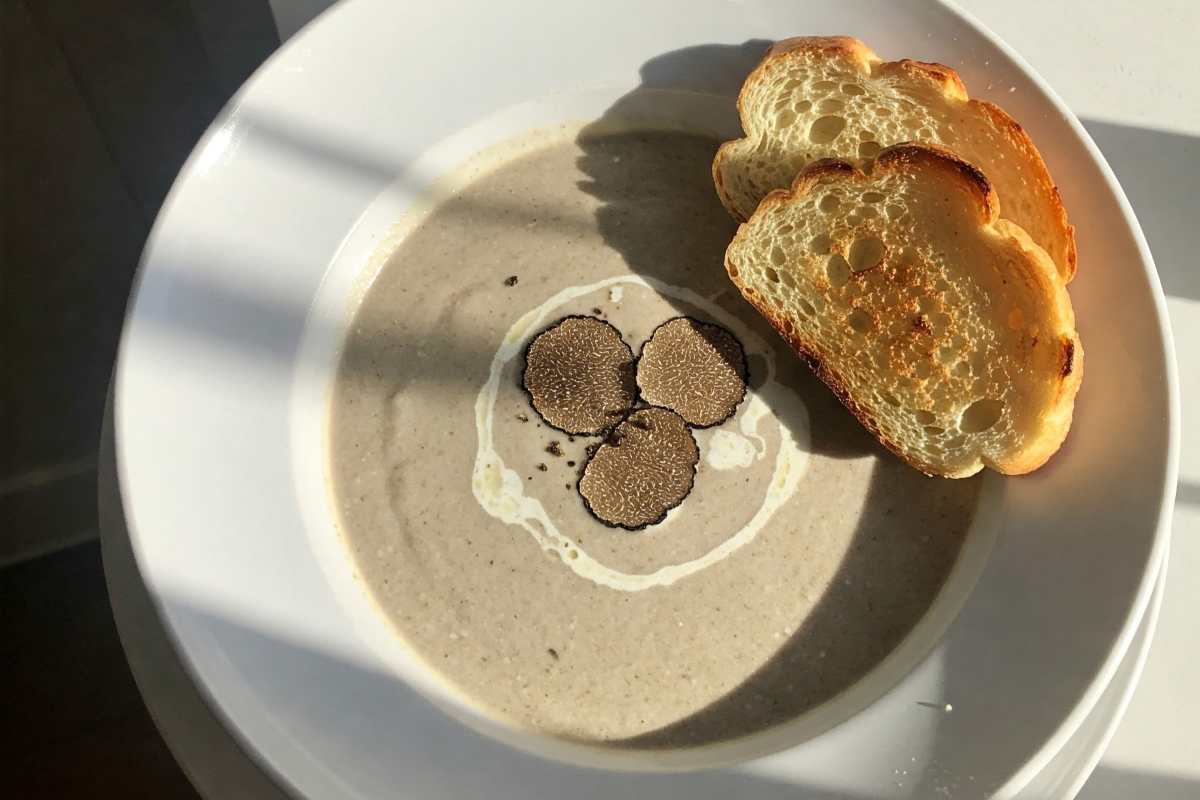Toasted bread served alongside truffle mushroom soup.