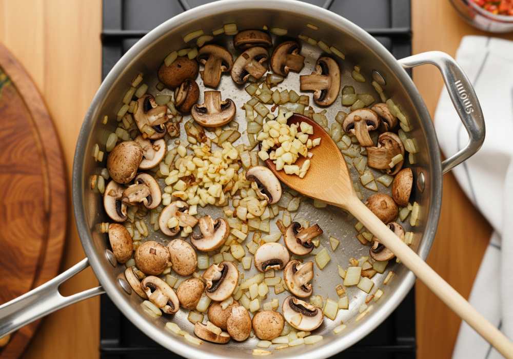 Mushrooms browning with onions and garlic, ready to turn into soup.